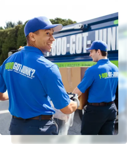 1-800-GOT-JUNK? team picking up junk to bring to junk removal truck