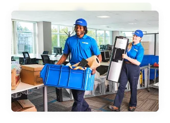 Two 1-800-GOT-JUNK? team members removing junk inside a business 