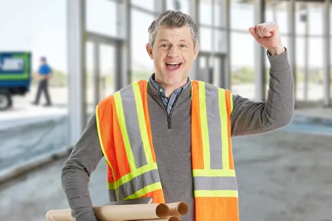 happy contractor at decluttered site with junk removal truck 