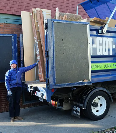 man with junk trunk filled with recyclable material